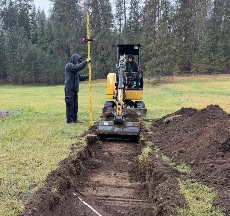 A plumber excavating a trench