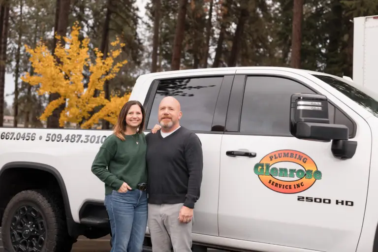 Heather & Bruce Ragle standing infront of their work truck